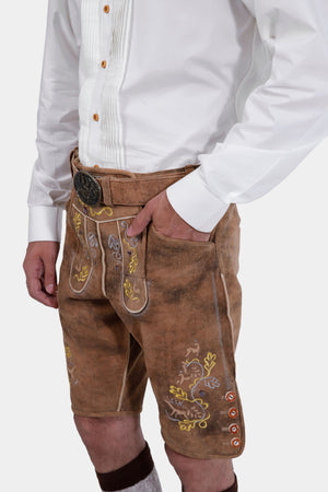 Close-up of the Gerd Muller Lederhosen highlighting the detailed floral embroidery and buttoned pockets