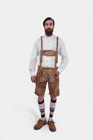 Full front view of the man in Gerd Muller Lederhosen, exuding a classic Bavarian look with knee-high socks and brown shoes.