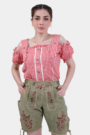 Woman wearing Halle Berry Lederhosen in Olivewood Leaf, paired with a red and white checkered blouse, front view.