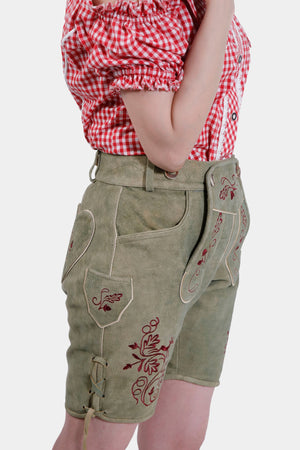 Side view of the Halle Berry Lederhosen in Olivewood Leaf, highlighting the side knife pocket and natural-colored embroidery on the legs.