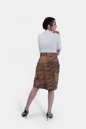 Back view of women wearing a traditional brown leather Karoline Lederhosen Skirt with subtle embroidery, paired with a white blouse featuring a polka-dotted inner collar
