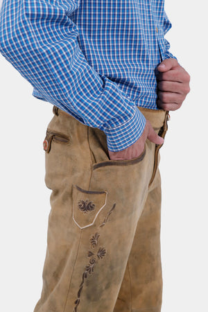 Closed side view of a man wearing Kochelsee Lederhosen Long pants paired with light blue checkered shirt