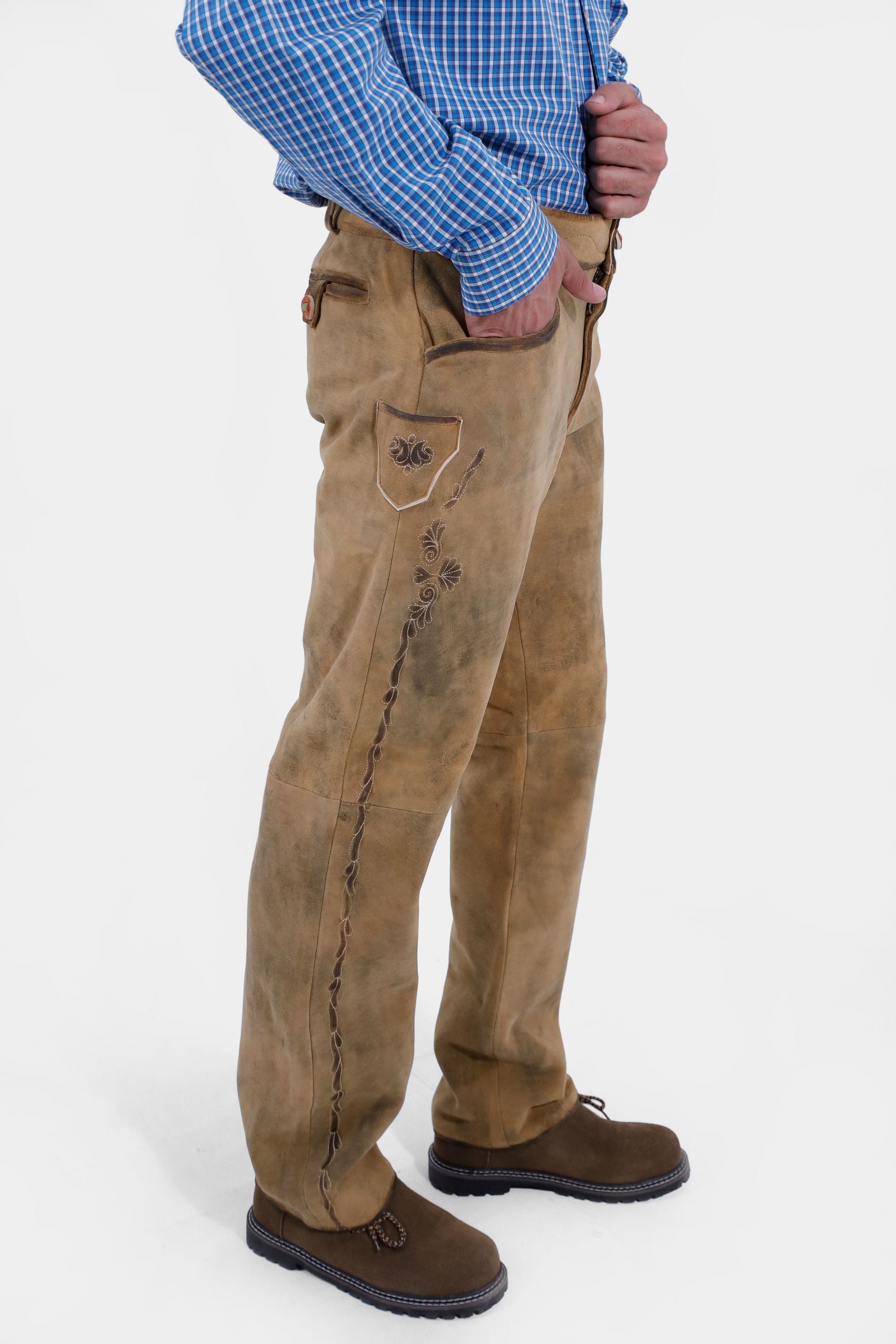 Closed side view of a man wearing Kochelsee Lederhosen Long pants paired with light blue checkered shirt