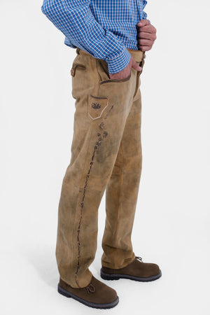 Closed side view of a man wearing Kochelsee Lederhosen Long pants paired with light blue checkered shirt