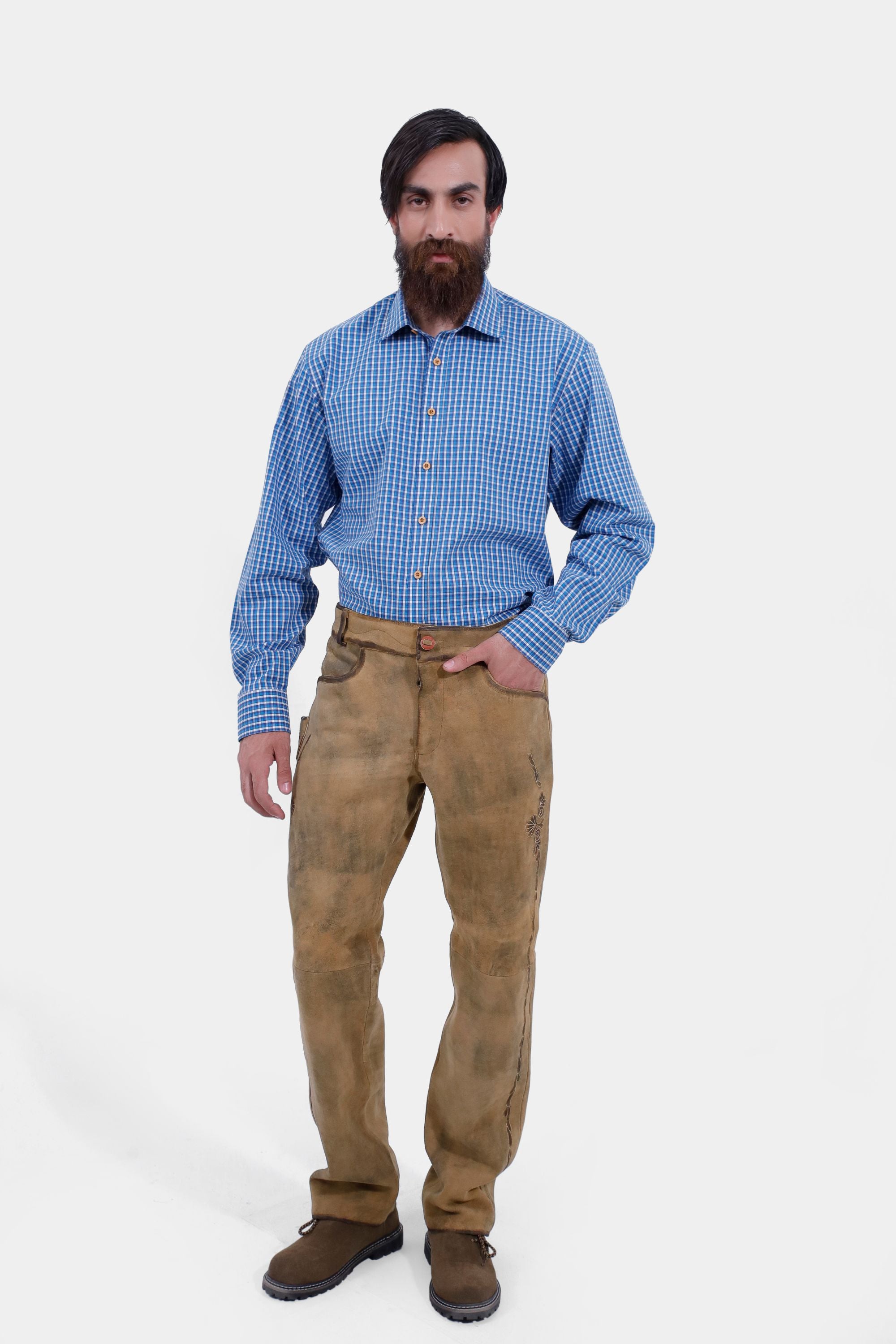 Complete side view of a man wearing Kochelsee Lederhosen Long pants paired with light blue checkered shirt