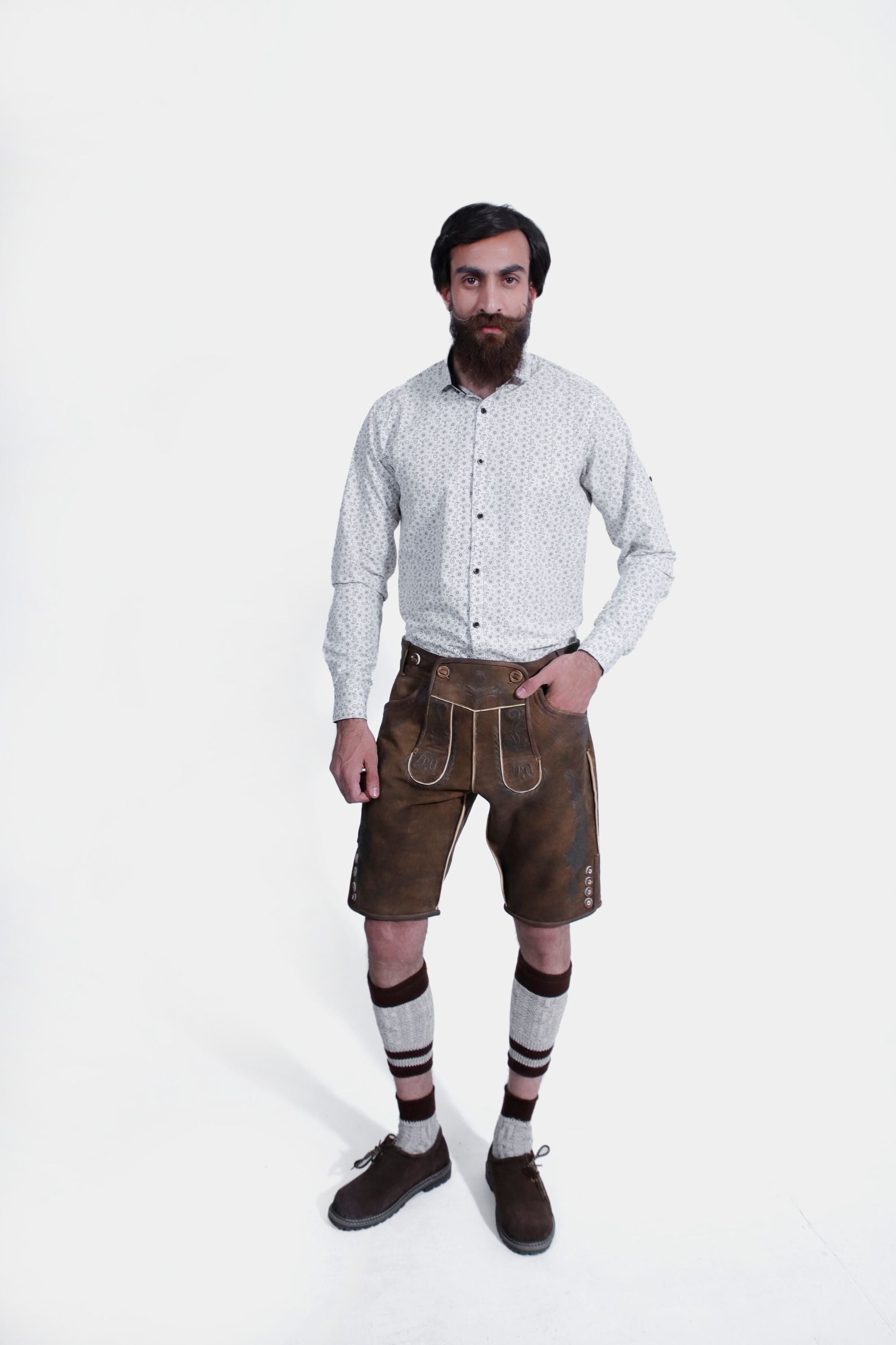 Lechfall Legend Lederhosen in Rustic Mahogany, knee-length goat suede leather with natural embroidery, brown horn buttons, and multiple practical pockets.