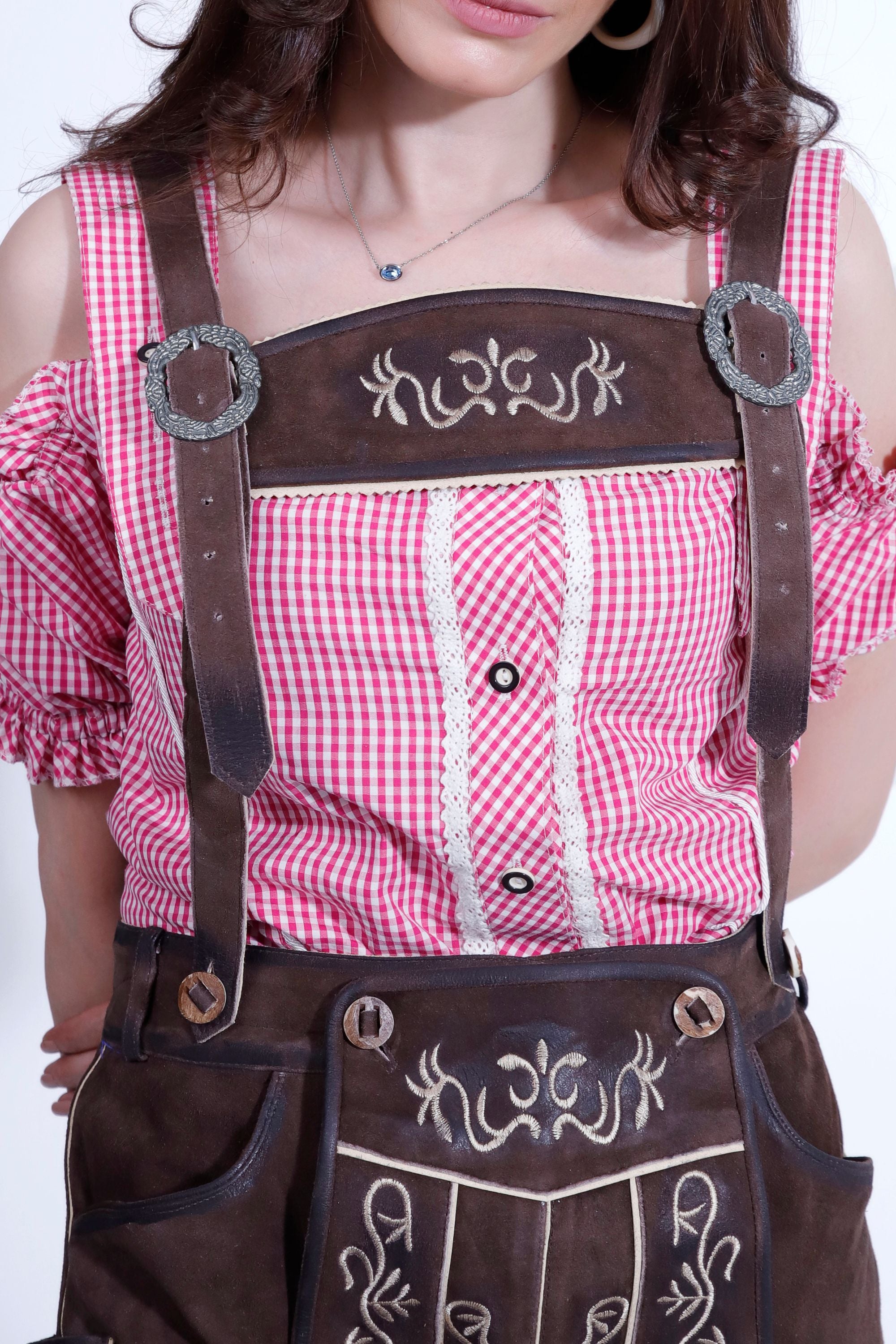 Detailed view of the Liesel Pritzker Lederhosen with traditional embroidery and suspenders.