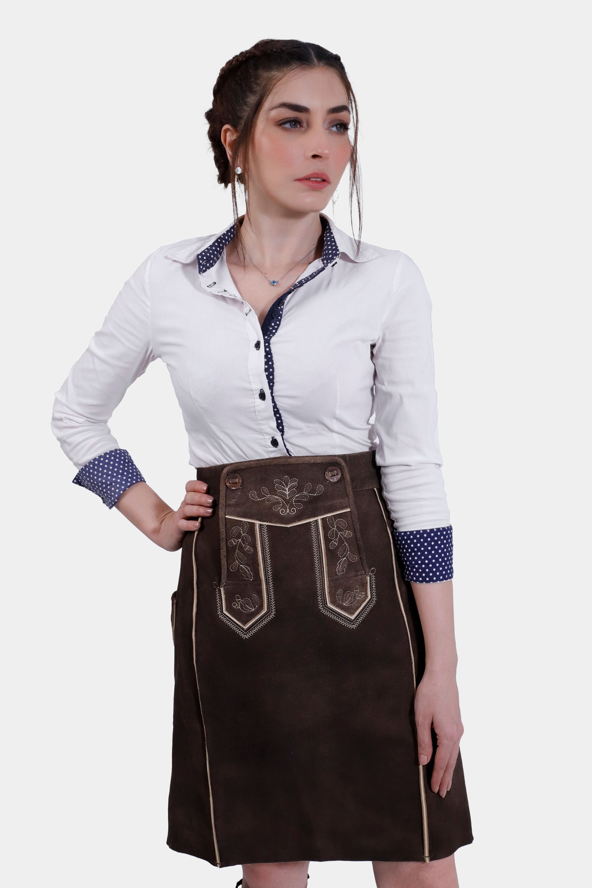 Woman wearing the Lillian Lederhosen Skirt in Tyrolean Chocolate, front view with hands on hips.