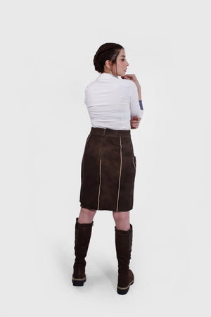Side profile of a woman in the Lillian Lederhosen Skirt, emphasizing the skirt's fit and detailing.