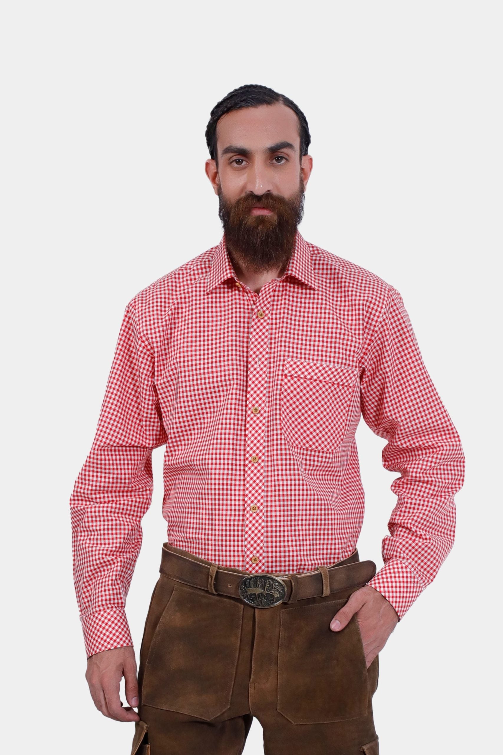 A man wearing the Loras Lederhosen Red Shirt, a red and white checkered long-sleeve shirt with a front pocket, paired with dark brown leather Lederhosen. This traditional Bavarian outfit is ideal for Oktoberfest and other cultural events, offering a vibrant and authentic look.