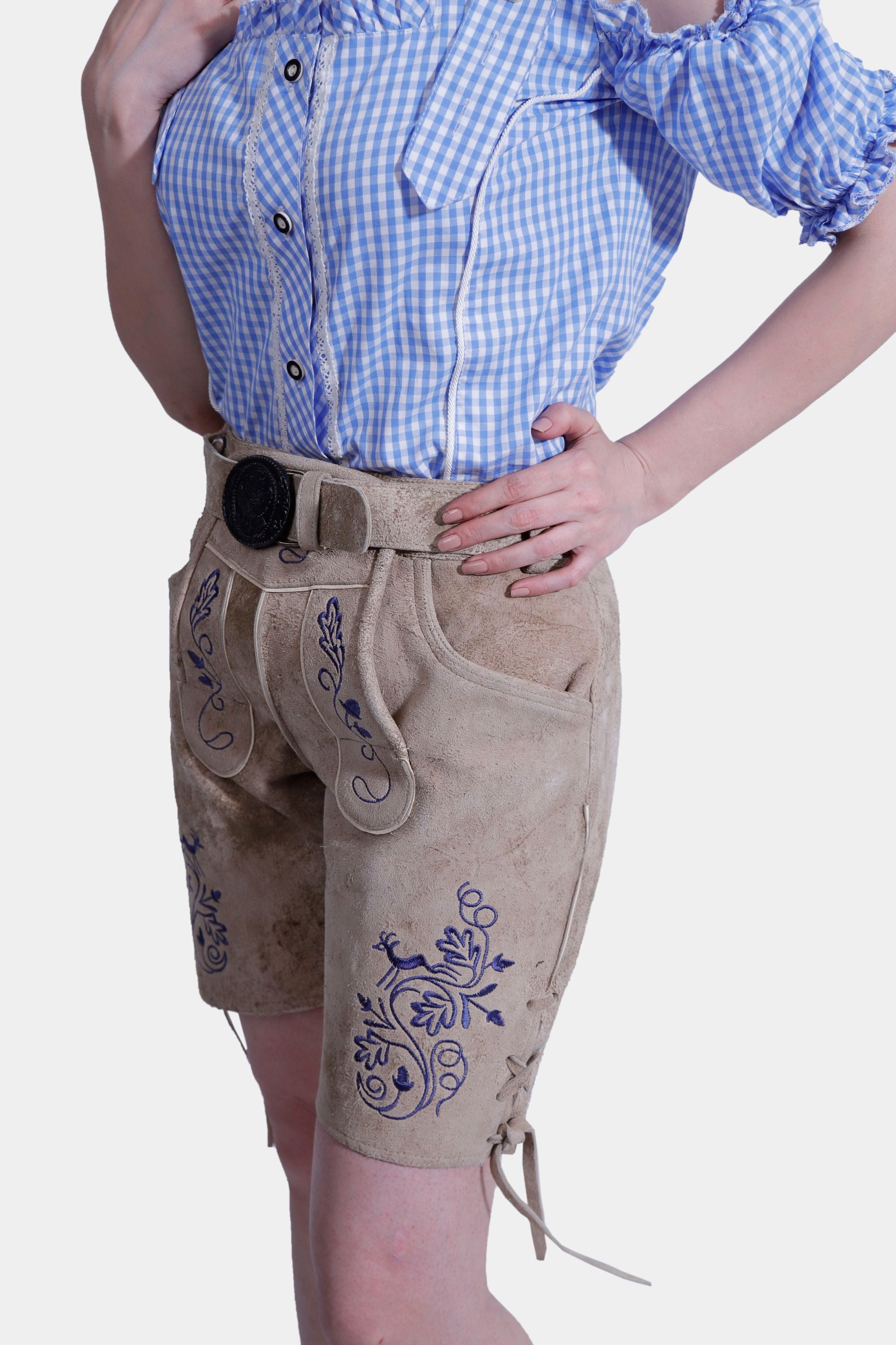 Side close-up showing the embroidery and belt on tan leather shorts.