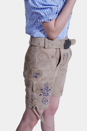 Side close-up showing the embroidery and belt on tan leather shorts.