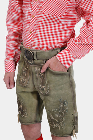 Side view of a man wearing traditional German lederhosen with a red checkered shirt, showcasing intricate embroidery.