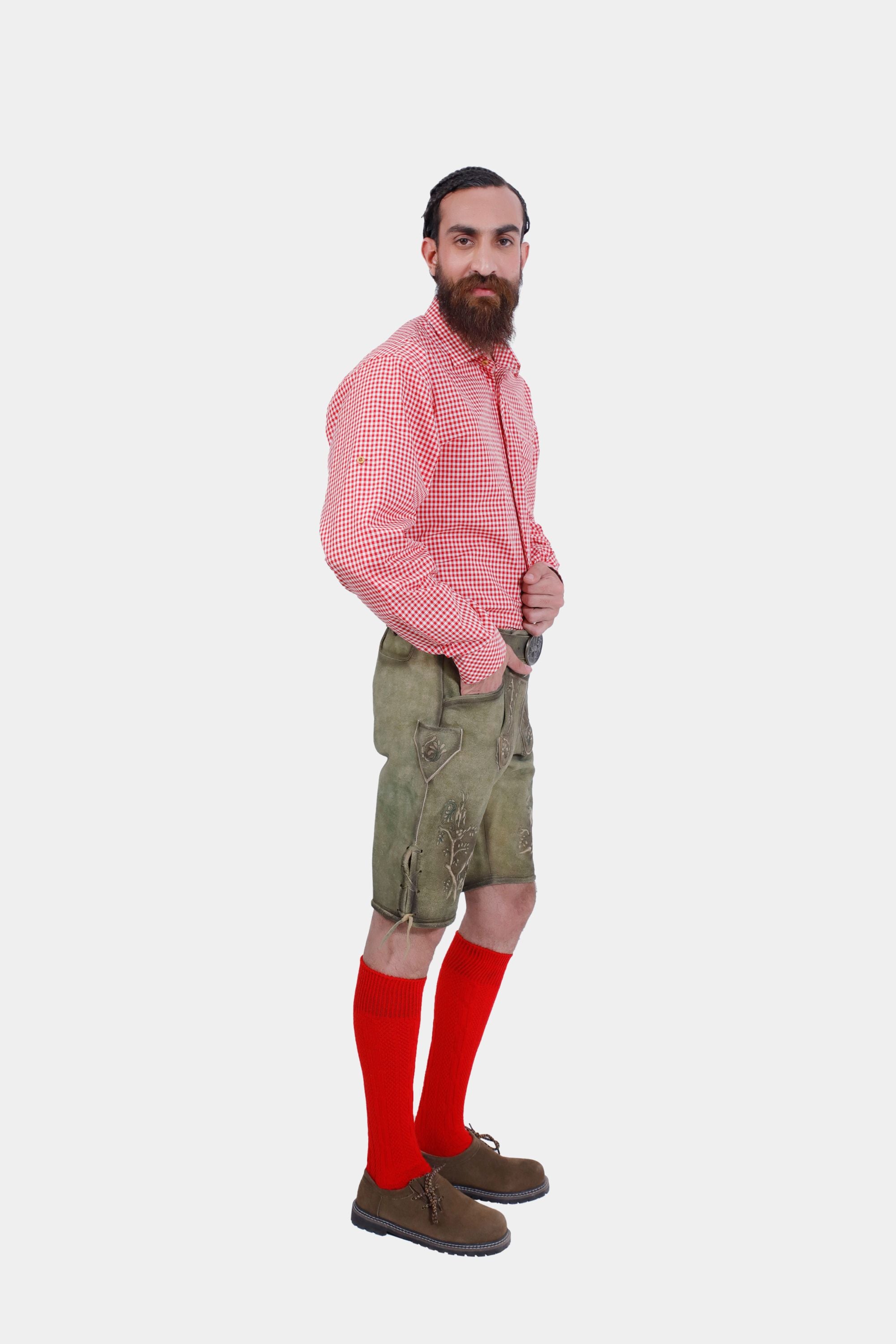 Side profile of a man in traditional German lederhosen with a red checkered shirt, showing detailed embroidery on lederhosen."