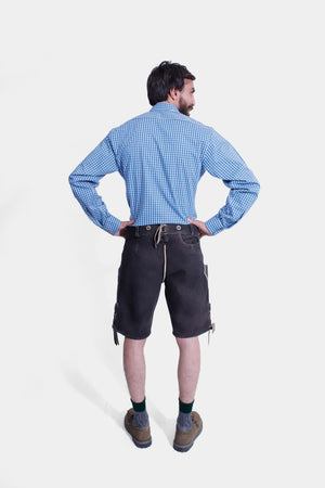 The back view of the man in Mountain Majesty Lederhosen, showing the back design and fit of the lederhosen and the shirt.