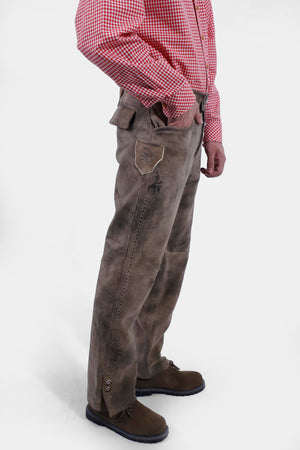 Closed side view of a man wearing lederhosen long paired with red checkered shirt and brown matching shoes