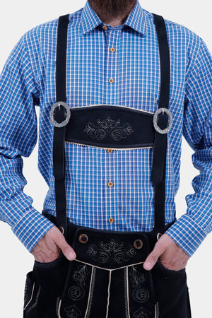 Close-up of the man's upper body, showing the blue checkered shirt and black Bundhosen with suspenders. The suspenders are adorned with silver buckles and detailed embroidery on the front panel.