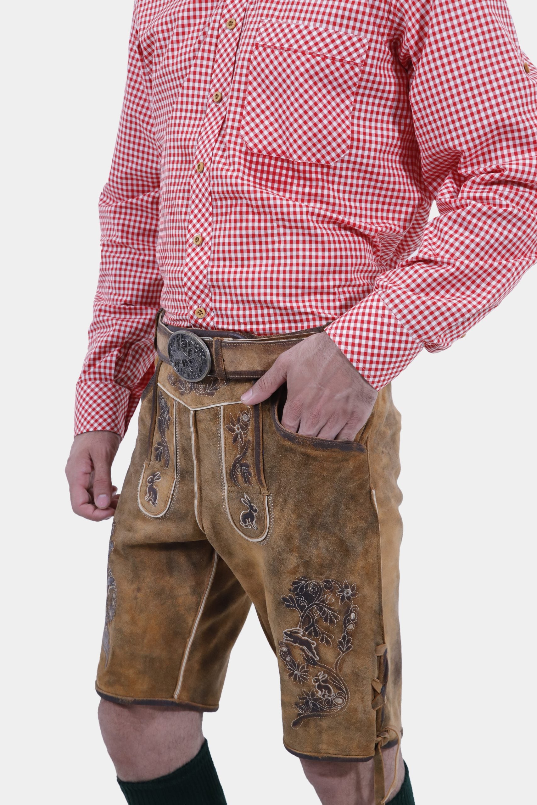 Right Side profile of a man dressed in Oktoberfest Tulsa Lederhosen and a red gingham shirt, highlighting the side ties and embroidery of the lederhosen."