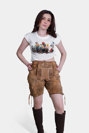 Full-body shot of a woman Royal Saxony Lederhosen in tan lederhosen and a white T-shirt, wearing brown boots.