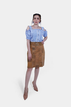 Full body women in Rustic Dream Lederhosen Skirt, Sunset Bronze goat suede, with blue gingham top.