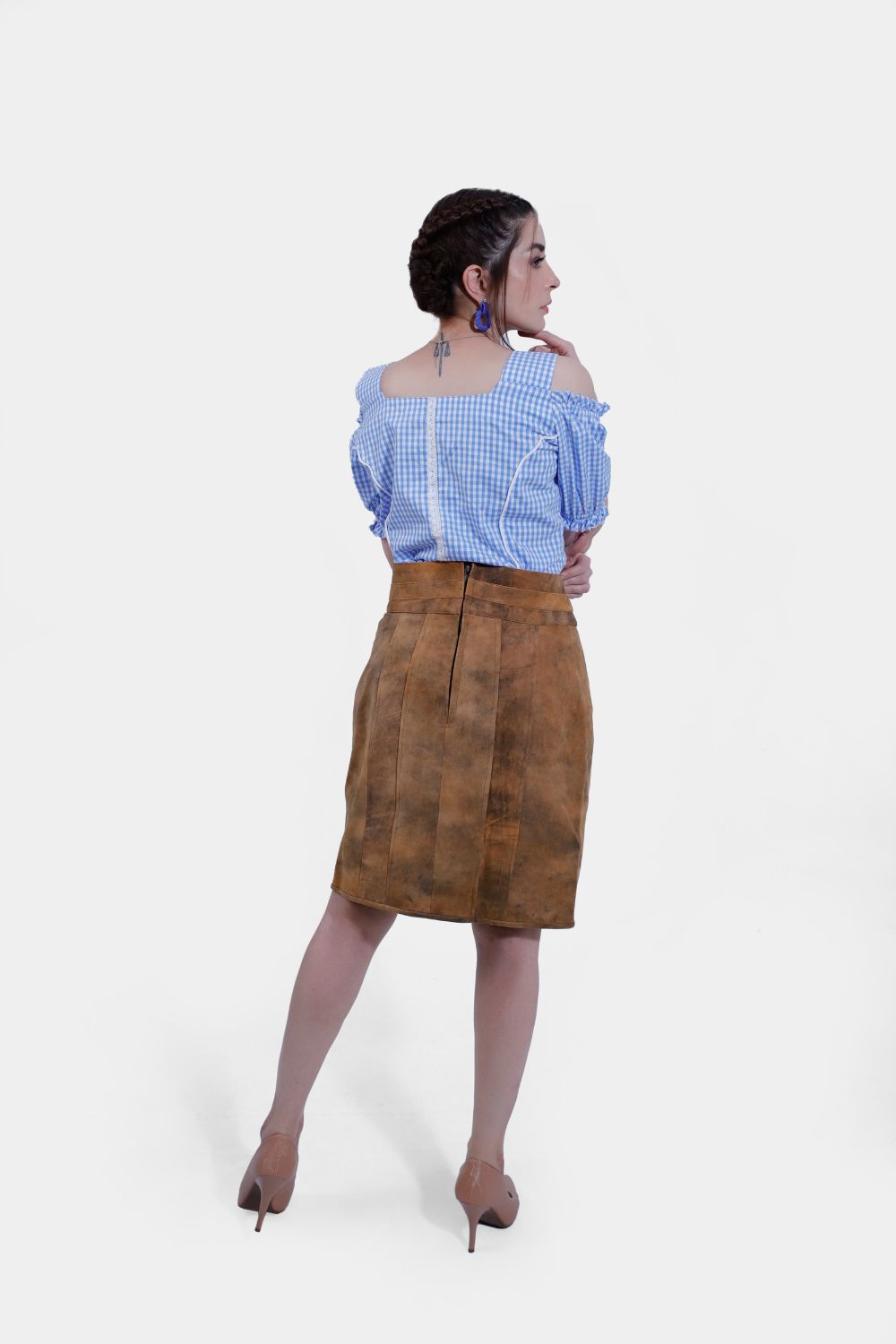 Model in Rustic Dream Lederhosen Skirt, Sunset Bronze goat suede, with blue gingham top.