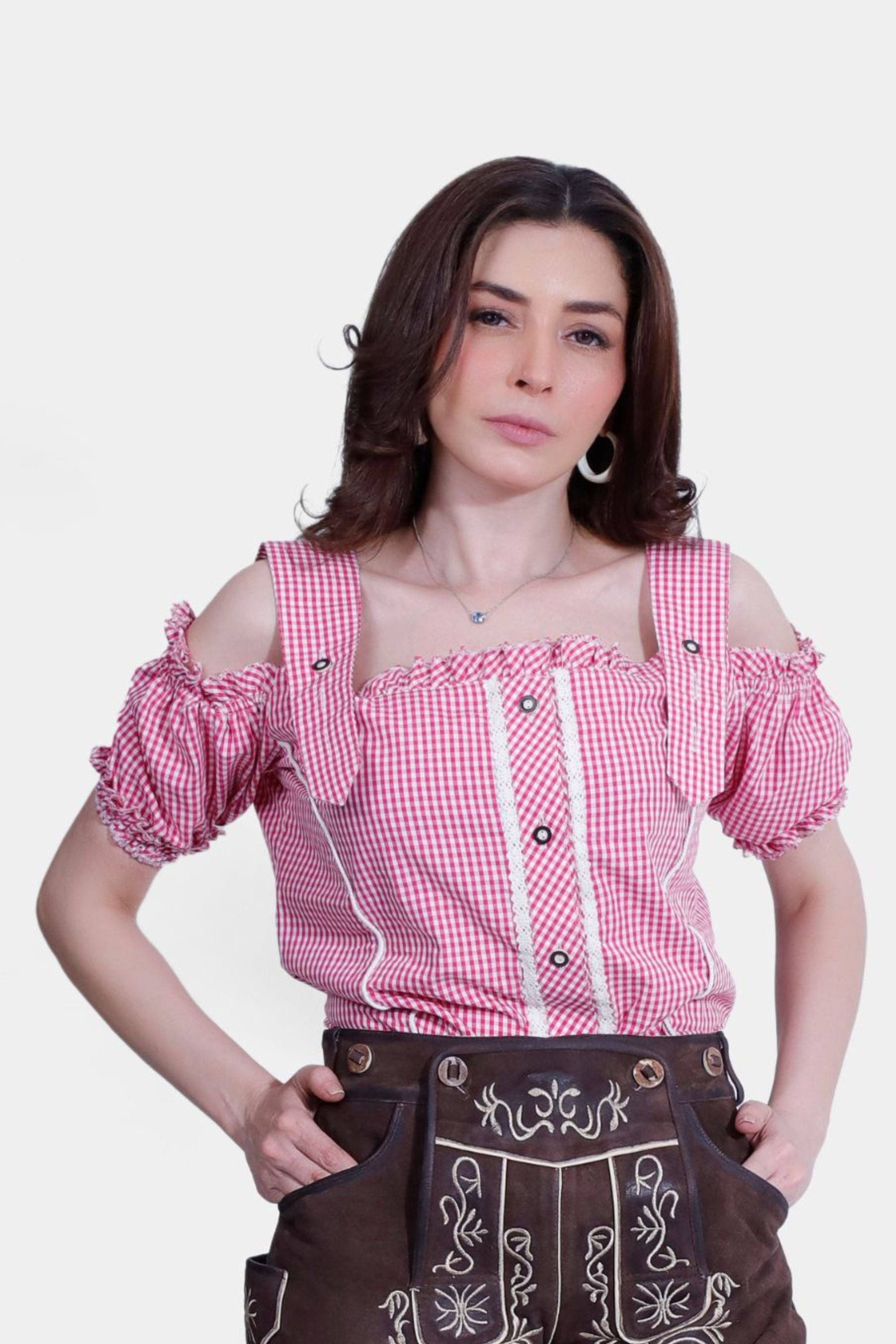 Woman wearing a red and white checkered Sarah Traditional Blouse, front view.