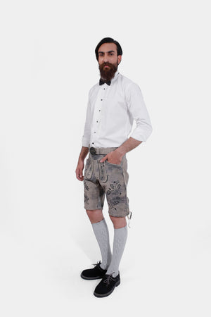 Man modeling Staffelsee Sunset Lederhosen, highlighting the knee-length fit and traditional Bavarian design