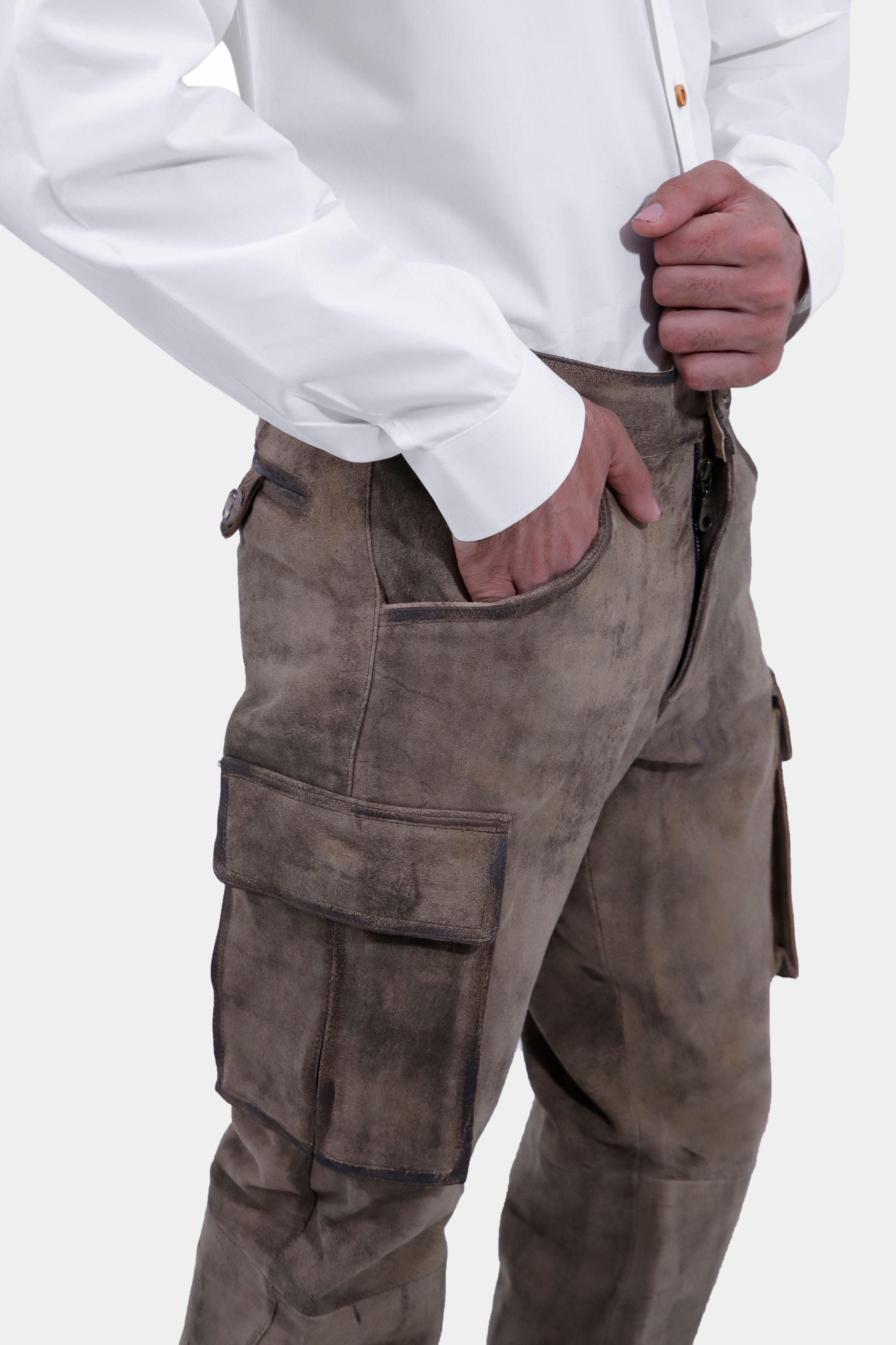 closed side view of a man wearing stamberg cargo long lederhosen paired with plain white shirt