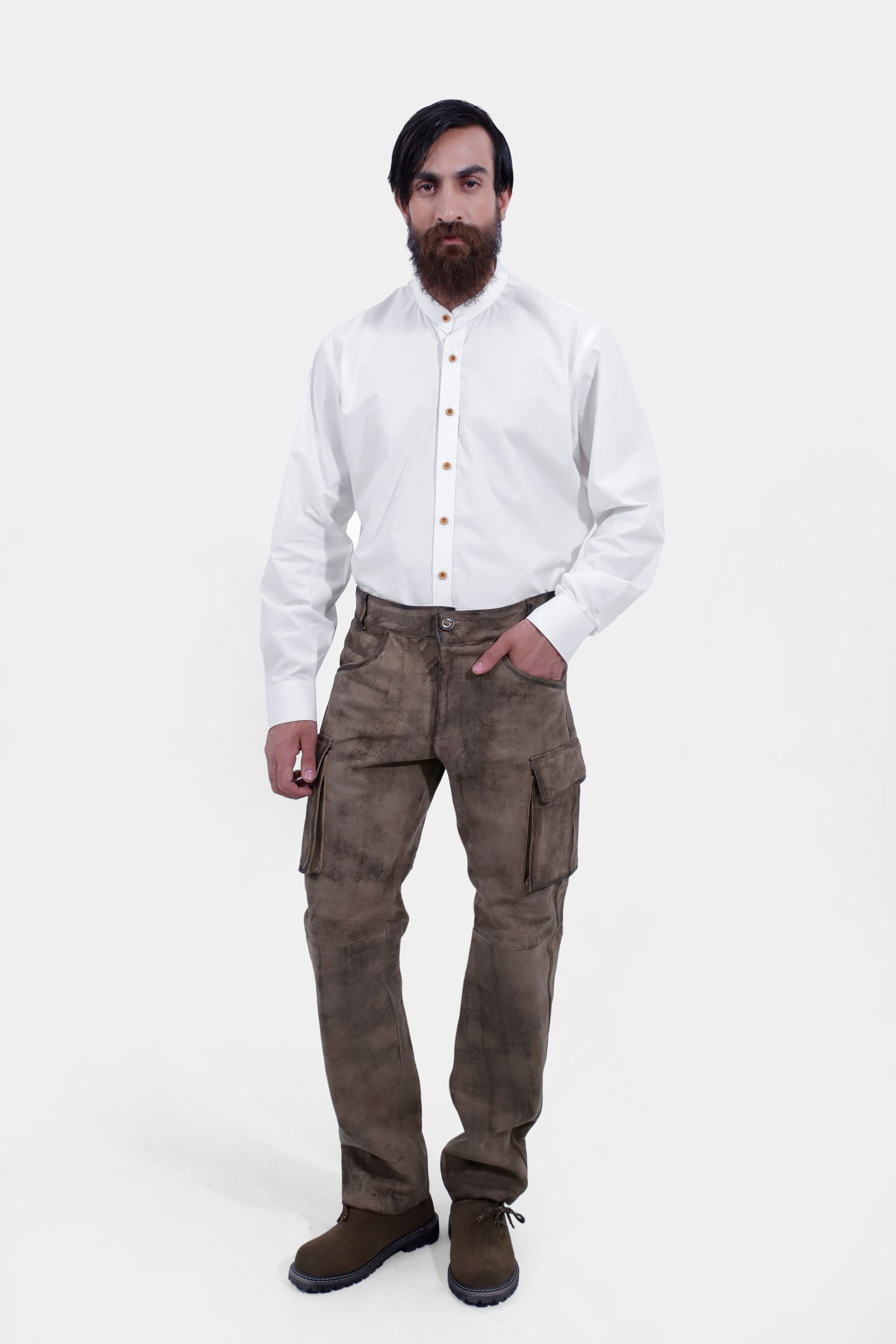 complete front view of a man wearing stamberg cargo long lederhosen paired with plain white shirt and dark brown shoes