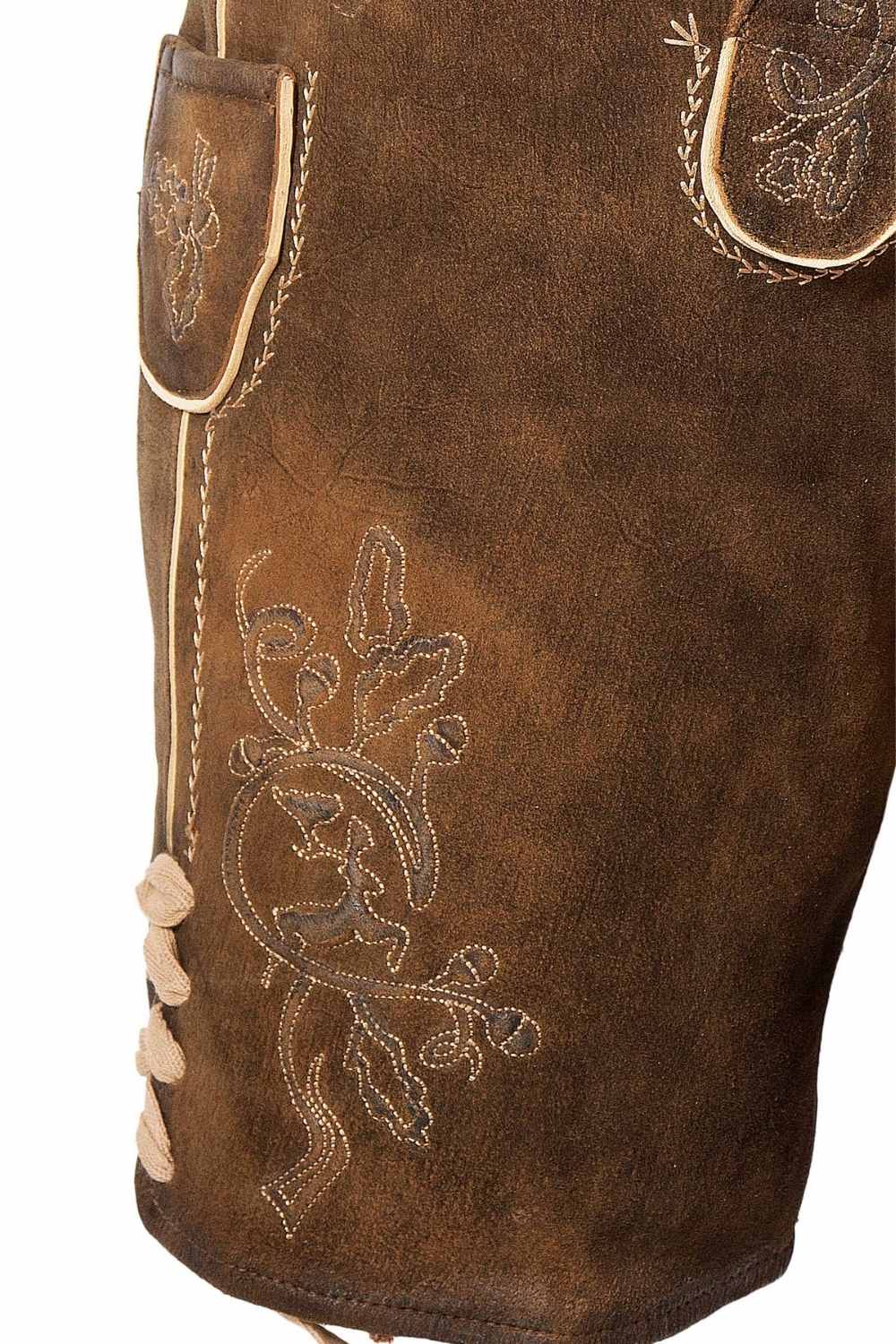 Side view of lederhosen bike shorts with decorative stitching and leather lace-up details, providing a rugged yet classic Bavarian look.