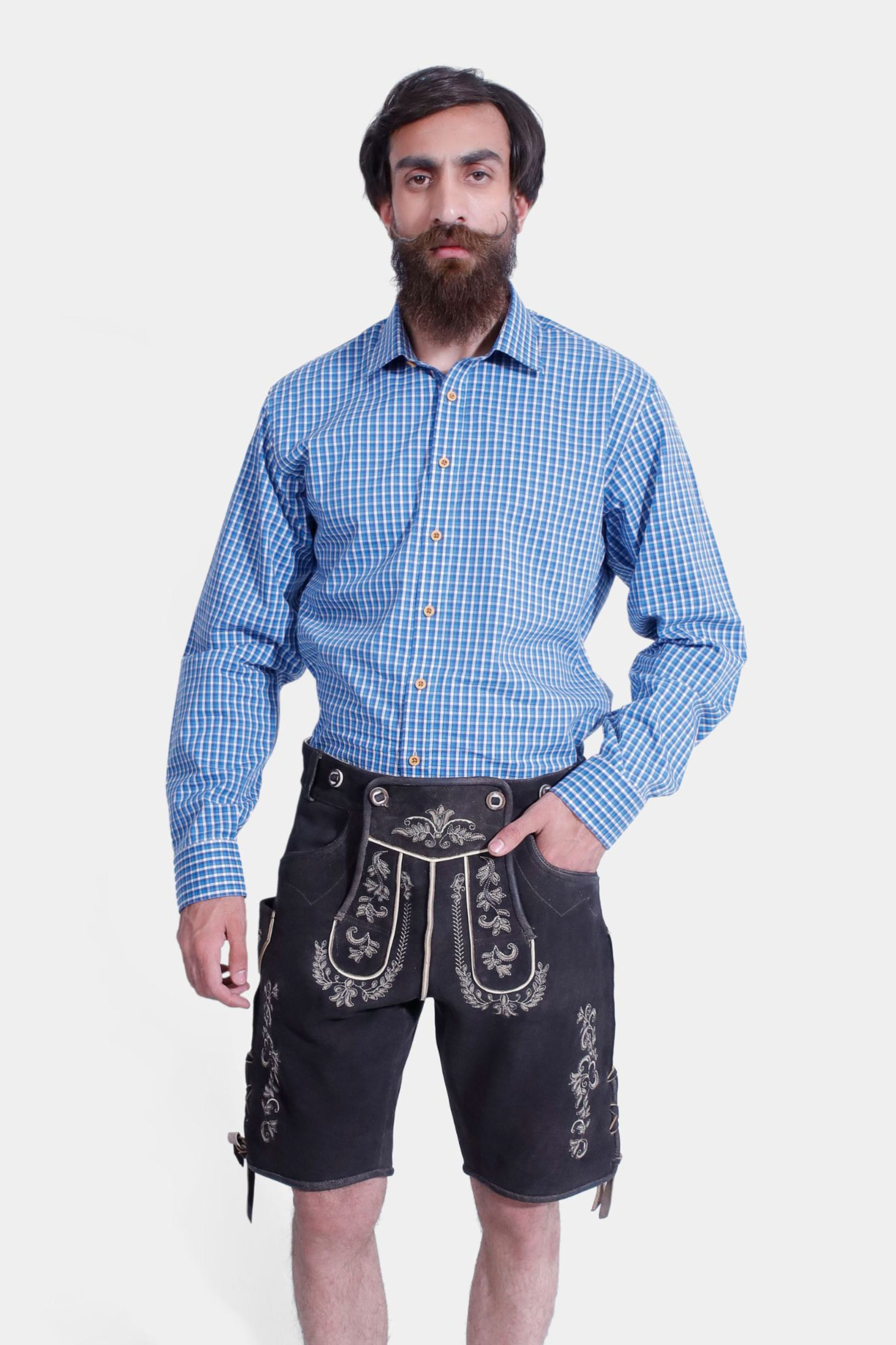 Close-up view of the Gert Fröbe Lederhosen Outfit, highlighting the detailed white embroidery on black leather shorts and the blue checkered shirt.