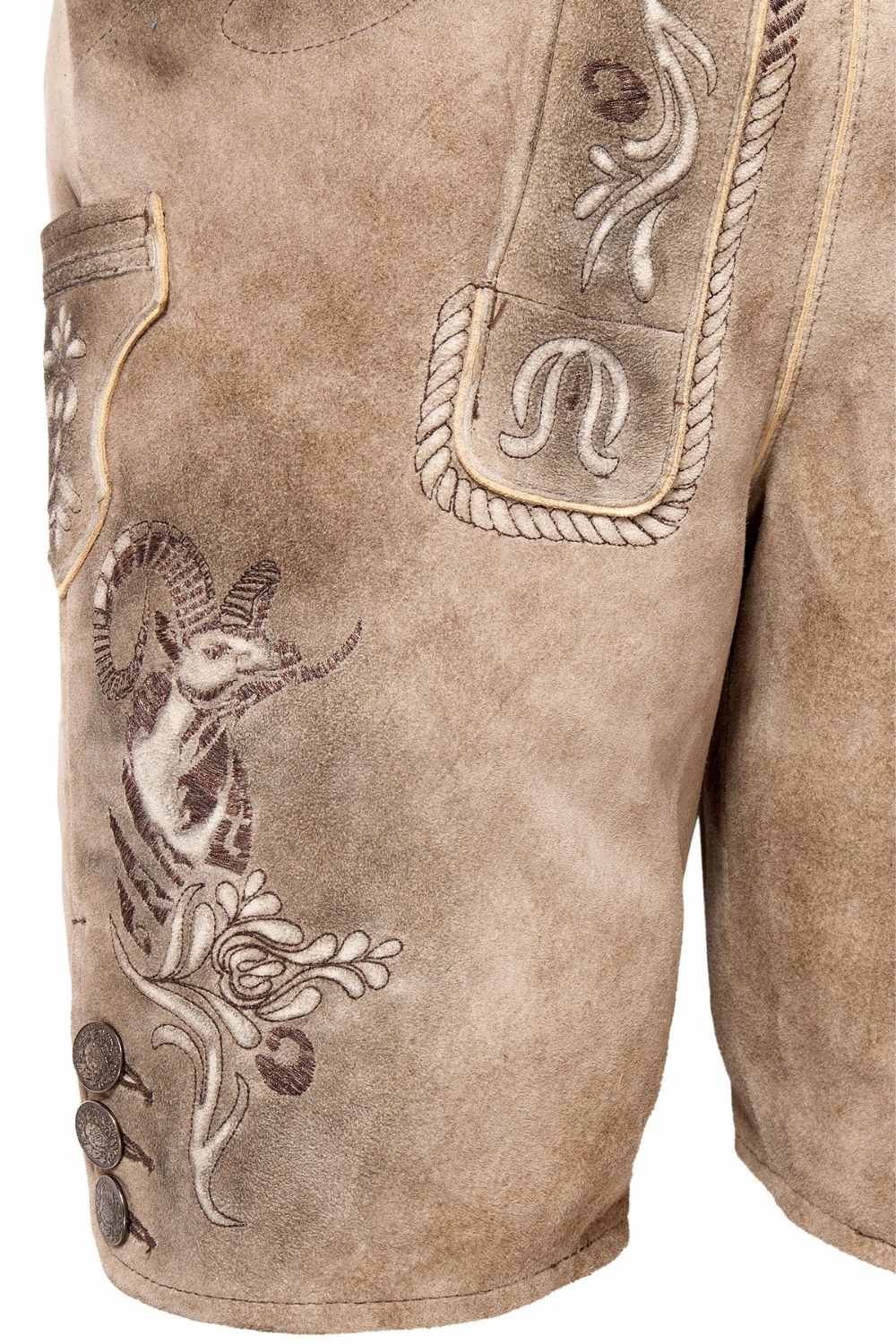 Side view of German short lederhosen with intricate goat embroidery and decorative buttons, embodying traditional German leather shorts craftsmanship