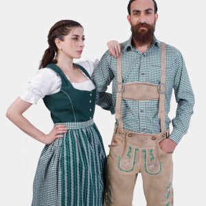 A man and woman in traditional Bavarian attire. The woman is wearing a green dirndl dress with a white blouse, while the man is dressed in beige lederhosen with green embroidery and a green checkered shirt. Both stand confidently, showcasing their stylish and coordinated outfits.