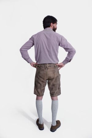 Rear view of a Man wearing "Chiemsee Castle Elite Lederhosen" in Opal Mist with intricate embroidery, paired with a checkered shirt.