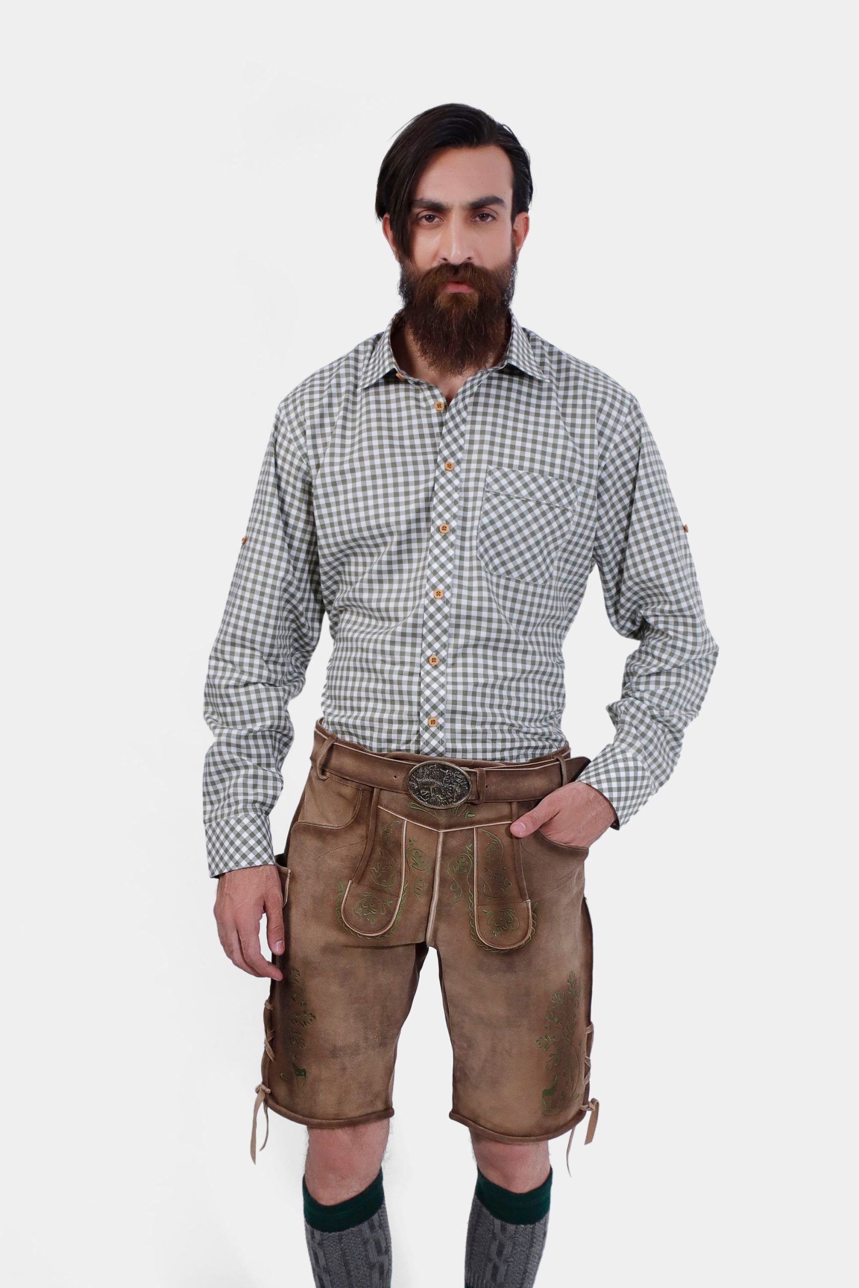 Man wearing Thuringian Forest Dragons Lederhosen with a checkered shirt, posing with hands in pockets