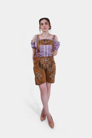Model in brown leather lederhosen shorts with white embroidery and suspenders, paired with a purple checkered blouse, showcasing the front and side details of the outfit