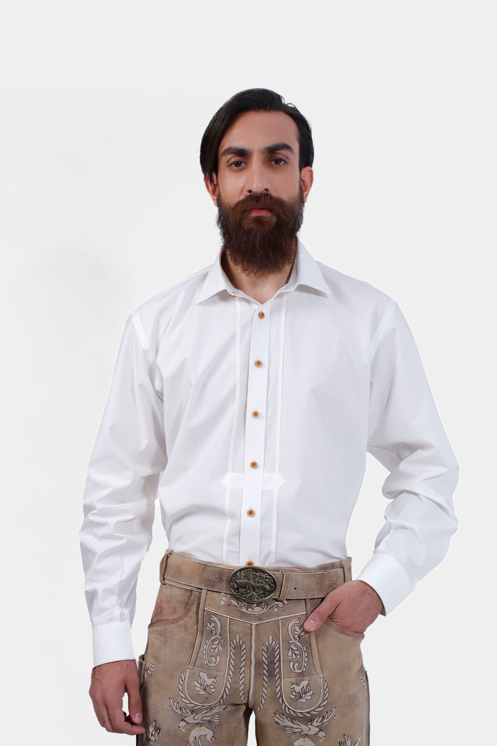 A man wearing the Kimmich Lederhosen Shirt, a white long-sleeve shirt with wooden buttons, paired with light brown embroidered Lederhosen. This traditional Bavarian outfit is perfect for Oktoberfest and cultural events, showcasing a classic and authentic look.