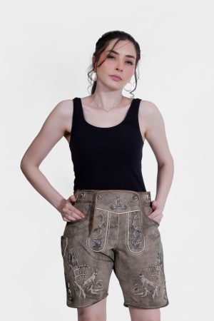Close-up of a woman wearing a black tank top and light brown Lederhosen with intricate embroidery. The shorts feature designs of animals and floral patterns, set against a plain white background.