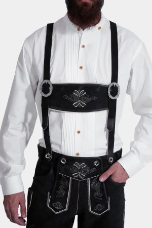 Man wearing Black Edelweiss Lederhosen in Obsidian Twilight with natural embroidery, white shirt, and suspenders