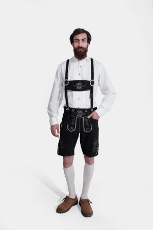 Complete front view of a man wearing Black Edelweiss Lederhosen in Obsidian Twilight with natural embroidery, white shirt, and traditional knee-high socks.