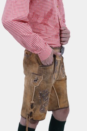 Side profile of a man dressed in Oktoberfest Tulsa Lederhosen and a red gingham shirt, highlighting the side ties and embroidery of the lederhosen.