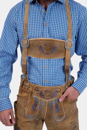 Man wearing Daniel Brühl Lederhosen with suspenders, showcasing detailed embroidery on the bib and legs.
