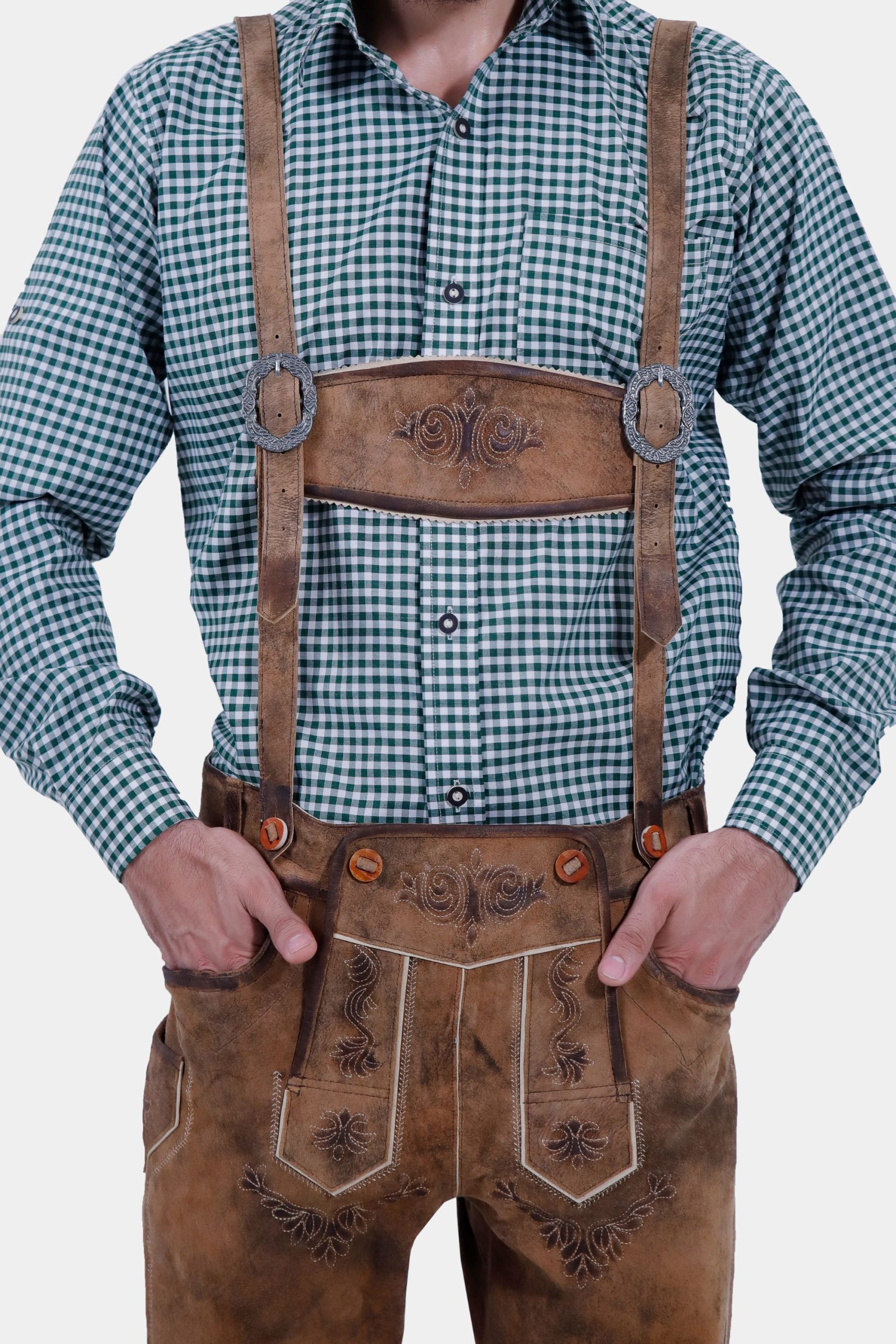 Man wearing Acropolis Suspenders made of high-quality leather, featuring intricate alpine embroidery, paired with Acropolis Bundhosen and a green checkered shirt.