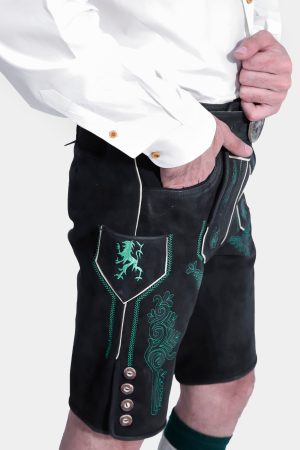 Detailed view of the front embroidery and pockets of the black Lederhosen, complemented by the white Bavarian shirt with gold buttons, emphasizing the traditional elements of the outfit.