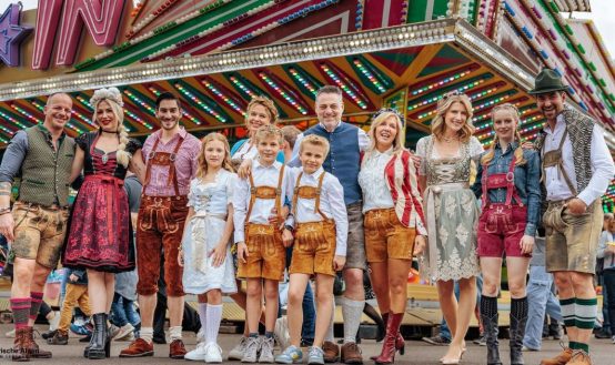 Happy Group in Traditional Bavarian Lederhosen and Dirndls at Oktoberfest