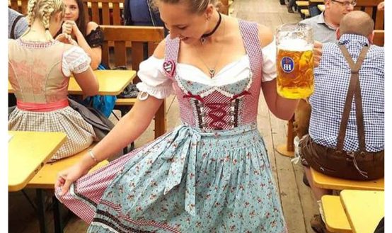Woman Wearing Traditional Dirndl Dress at Oktoberfest Beer Tent